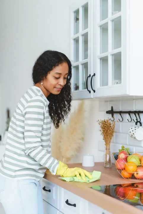 Homeowner wiping down kitchen counters