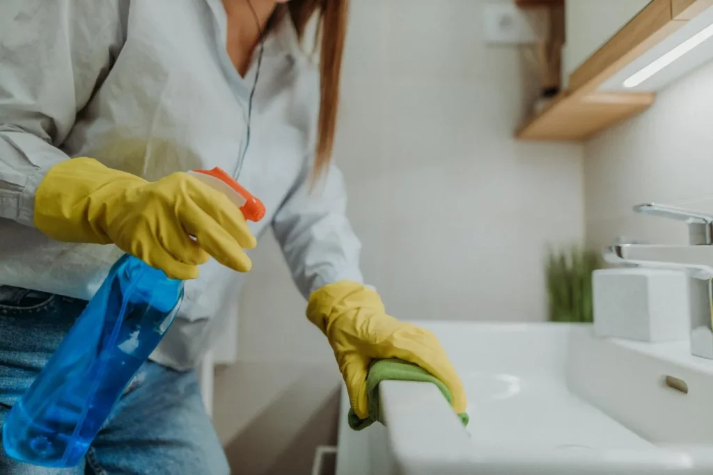 Woman deep cleaning bathroom sink