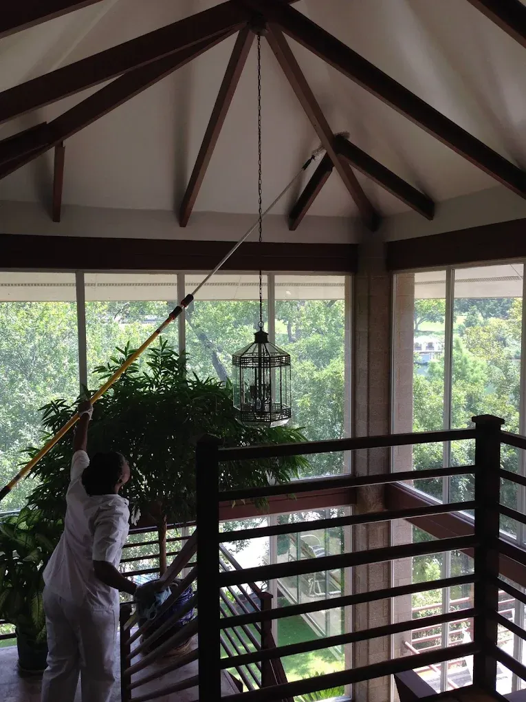 Maid cleaning ceiling during deep cleaning in Austin, TX